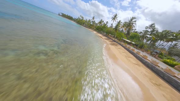 Crazy racing drone flight over playa Punta Popy at Las Terrenas in Dominican Republic. Aerial forwar