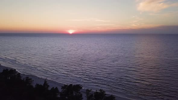 Drone footage of a sunset over Baltic Sea, Lubiatowo Beach, Poland. Pan Shot.