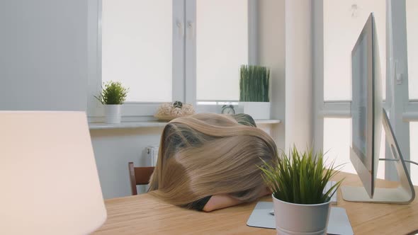 Tired Woman Waking Up at Workplace