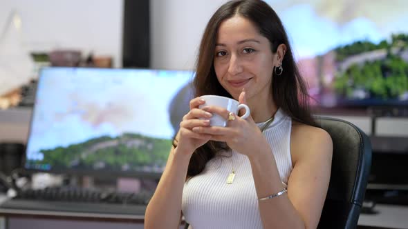 Woman Drinking Coffee in the Office