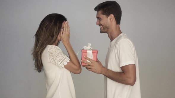 Man surprising girlfriend with gift