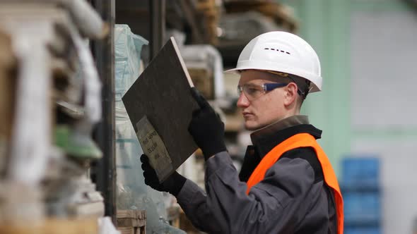 Young smiling worker checking board