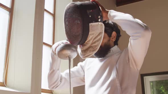 Fencer athlete during a fencing training in a gym