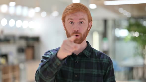 Portrait of Beard Redhead Man Pointing and Inviting