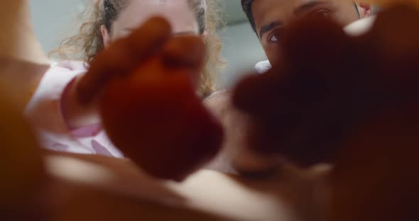 View From Inside Paper Bag of Indian Man and Caucasian Woman Taking and Eating Apples