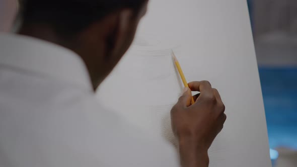 Close Up of African American Young Artist Using Hand with Pencil