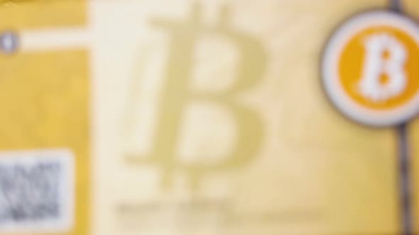 Bitcoin Logo Banknote Falls Down on Coins Pile