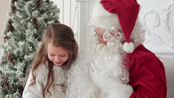 Litlle Girl Shaking Her Present From Santa Trying To Guess What Is Inside