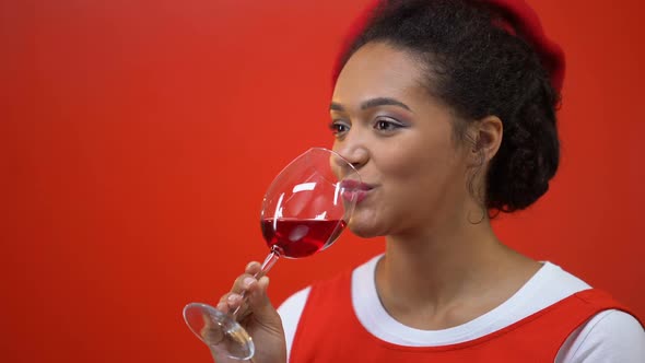 Cheerful Woman Drinking Red Wine Enjoying Taste and Aroma, Sommelier Profession