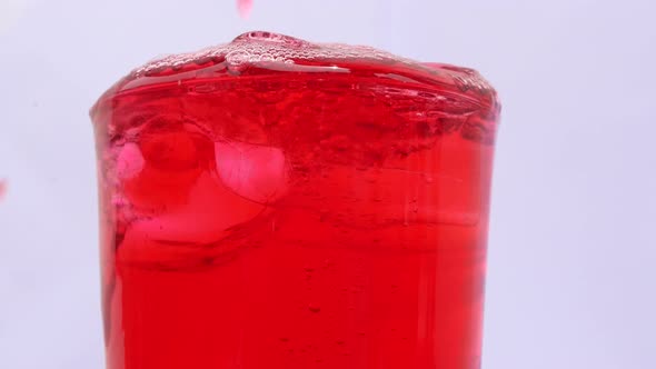 Red soft drink's bubble in a glass.