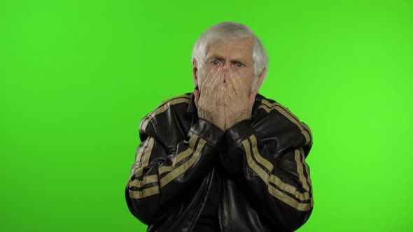Elderly Caucasian Grandfather Rocker Man Looks Surprised Shocked. Amazement