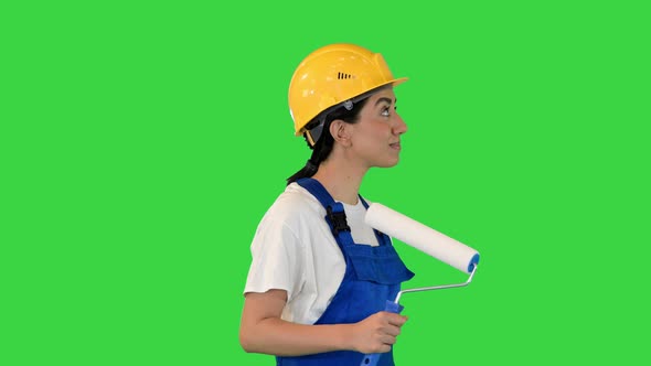 Female House Painter with Paint Brush Walking Looking What to Paint on a Green Screen Chroma Key