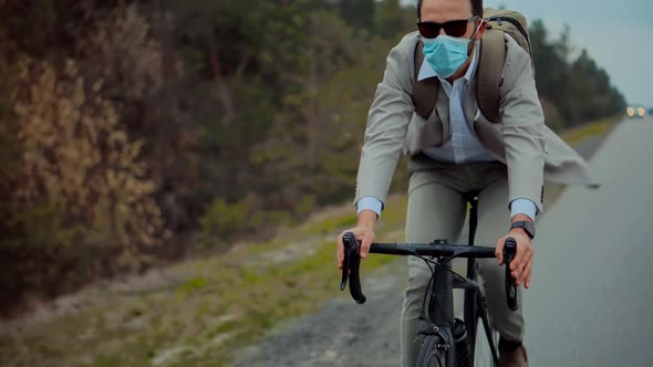 Manager Cyclist In Face Mask Travelling To Work. Cyclist In Suit Ride On Bicycle. Commute Cycling.