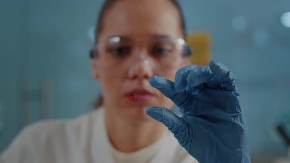 Chemical Specialist Holding Glass Tray with Blood Sample