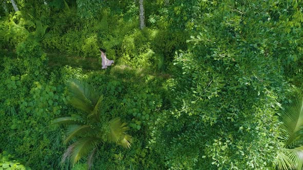 Girl Running On A Forest Path