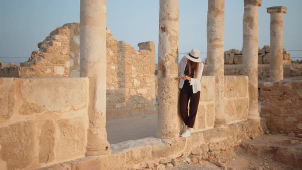 Competent Female Archeologist Standing Among Ruins of Ancient Temple