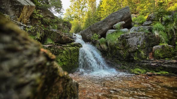 A small natural waterfall in the middle of the rocks