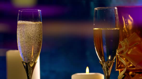 Pouring Two Flutes of Champagne By Candlelight
