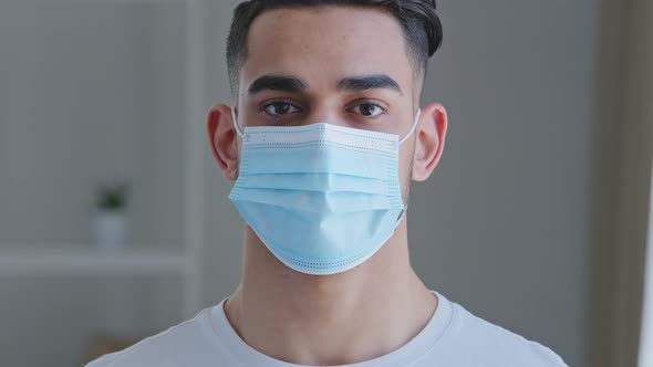 Portrait of Serious Confident Sick Arabic Spaniard Man Wears Protective Medical Mask Against