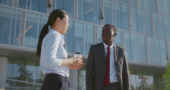 Diverse Business Coworkers Outside Office Building Drink Takeaway Coffee and Discuss