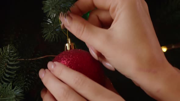 Woman's Hands Decorate the Christmas Tree with Toys in the Hotel Woman is Preparing for the