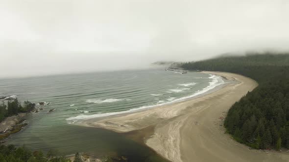 Aerial View of a Sandy Beach with Waves Coming From the Ocean.