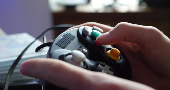 A child picking up a video game controller and playing with it.