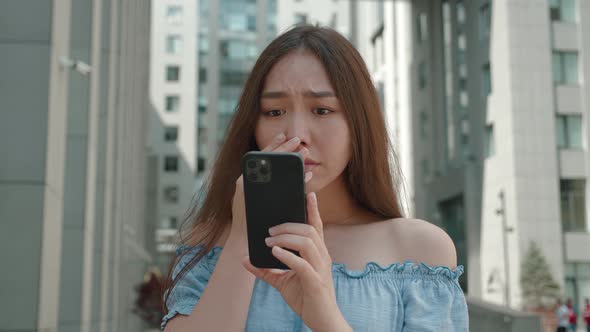 Shocked Frustrated Asian Woman Student Feel Stressed Look at Smartphone Screen Worried of Problem