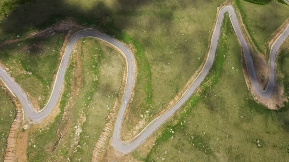 Cars passing through curve in mountain road. Mountain serpentine road