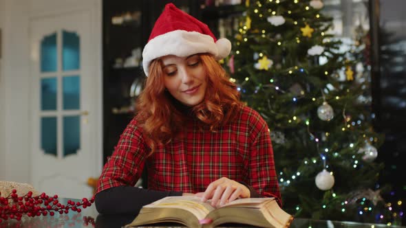 Young girl reads book at Christmas