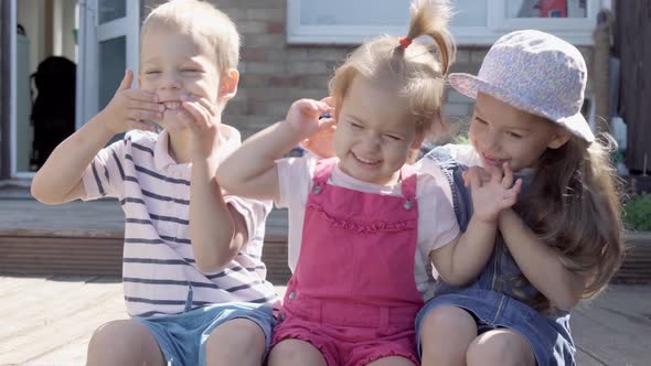 Three Cute Little Children Enjoys Delicious Ice Cream Cone