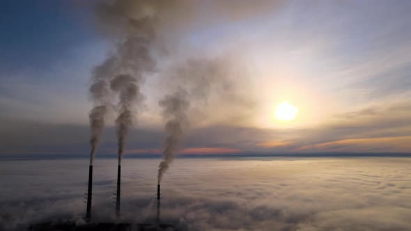 Coal Power Plant High Pipes with Black Smoke Moving Upwards Polluting Atmosphere