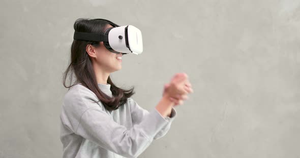 Woman playing game with VR device