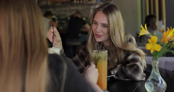 Woman Drinking Cocktail in Restaurant