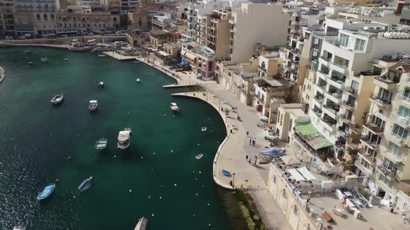 Aerial view of Spinola Bay in St Julien, Malta Island. There are many large buildings on the shores