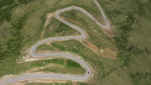 Cars passing through curve in mountain road. Mountain serpentine road