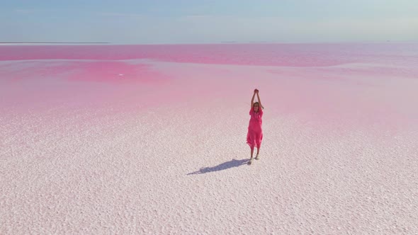 Cinematic Aerial Drone View of Colorful Pink Lake with Wide White Salt Coast Paradise Landscape