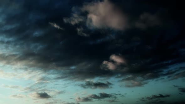 Time lapse cloudy sky. Gray and orange. 2 videos in one file. Clouds passing by. No flicker.