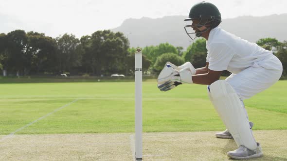 Side view of cricket player catching the ball