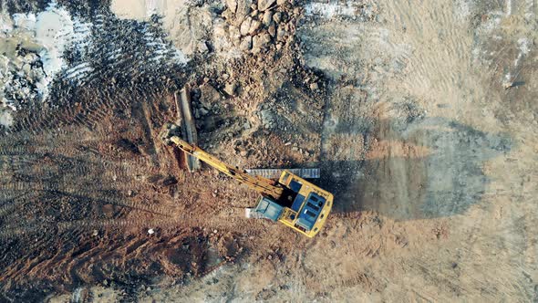 Excavating Machine Is Transporting a Piece of Metalware in a Top View