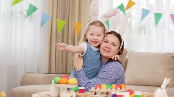 Mom and Little Daughter with Rabbit Ears Celebrate Easter and and Have Fun