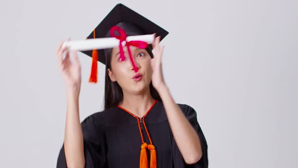 Beautiful Attractive Asian woman graduated in cap and gown smile