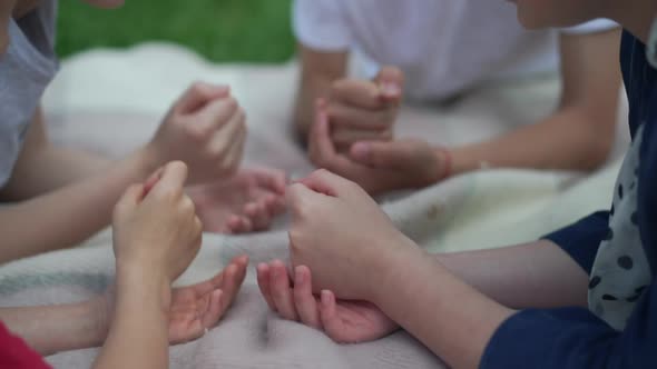 Caucasian Children Playing Rock Paper Scissors Gesturing in Slow Motion Outdoors