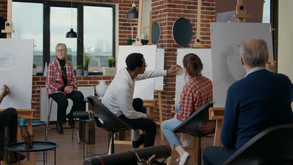 Diverse Team on Students Drawing Vase Model on Canvas