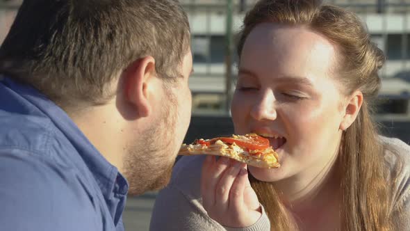 Smiling Obese Couple Enjoying Pizza Taste, Food Passion, Excess Weight Problem