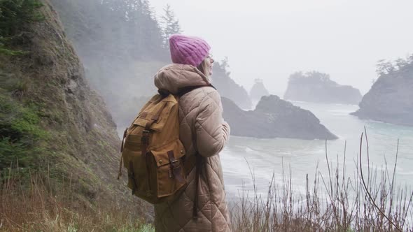Young Attractive Woman Enjoying Breathtaking Coast Landscape on Rainy Day USA