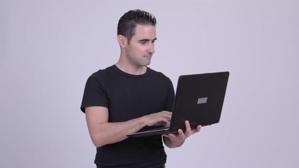 Handsome Man Using Laptop Against White Background