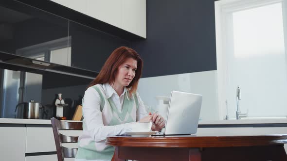 Woman Chatting Online and Drinking Coffee at Home