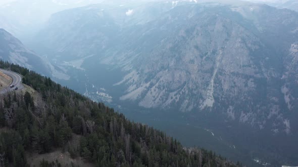 Aerial, car on road trip driving on Beartooth Highway in Montana and Wyoming