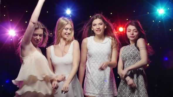 Young Smiling Girls Are Dancing, Stroboscope Lamps Provide Beautiful Lighting